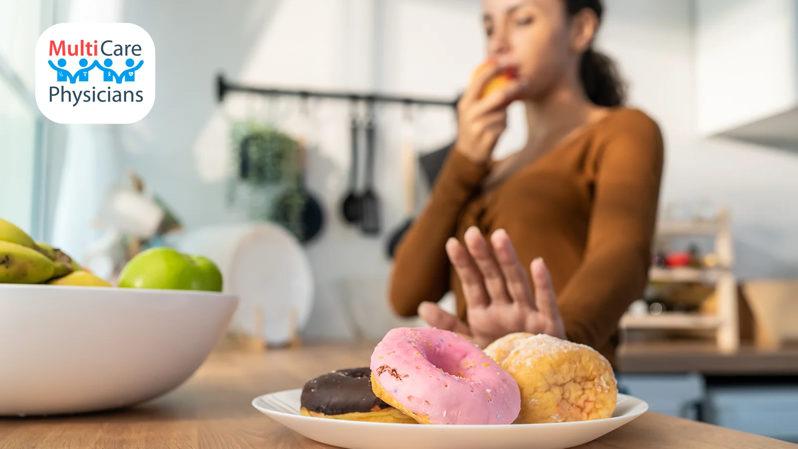 A woman rejecting a plate of donuts while choosing a healthier fruit option. MultiCare Physicians promotes smart dietary habits and guides patients on food diabetics should avoid, helping them maintain stable blood sugar levels.