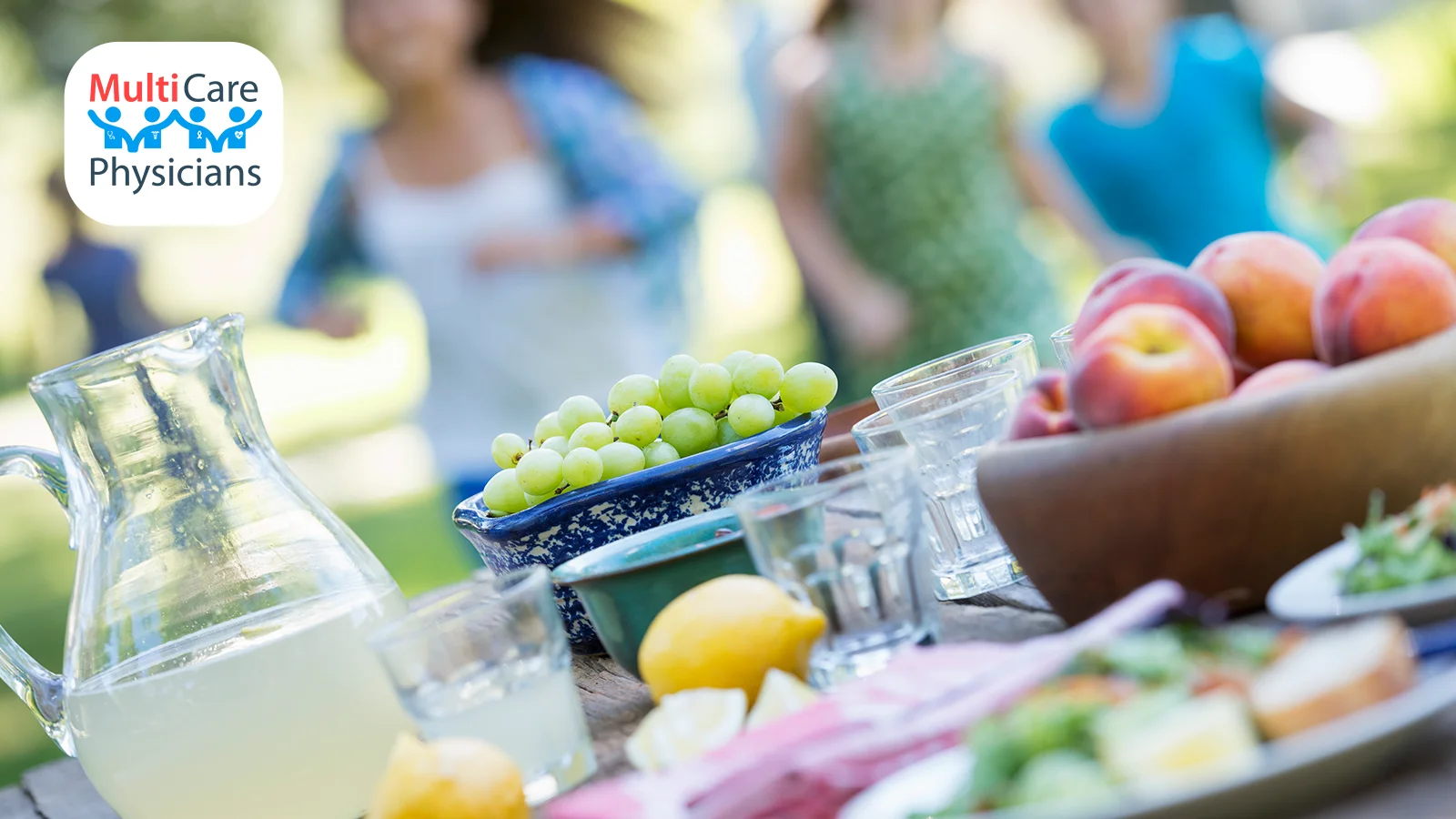 A table filled with fresh fruits, vegetables, and water, symbolizing a heart-healthy diet. MultiCare Physicians promotes nutrition and lifestyle changes to support patients in maintaining their blood pressure under control and achieving optimal health.